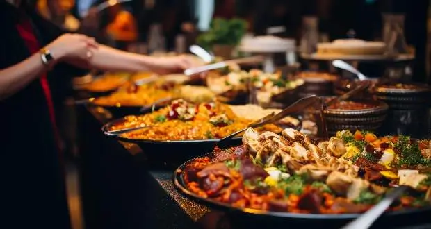 Professional catering staff serving guests at a buffet during a corporate event in London
