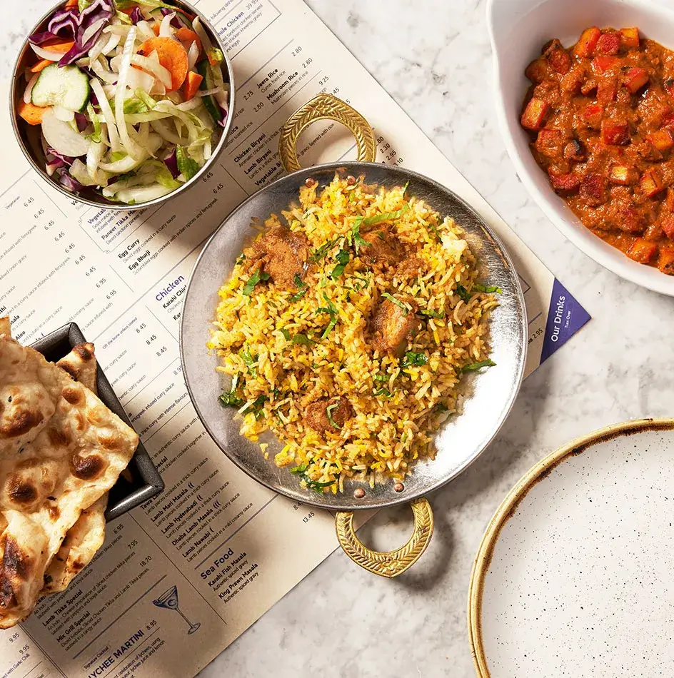 Plate of chicken biryani with saffron-coloured rice